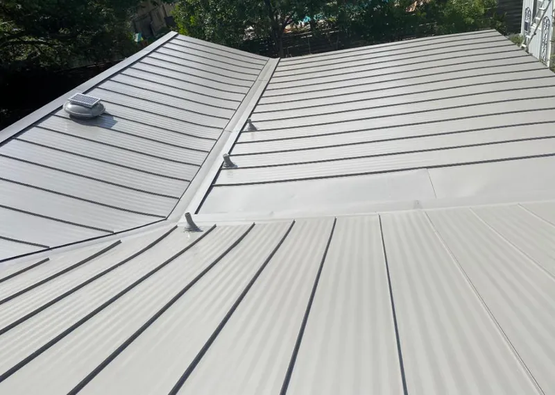 Solar attic fan installed on a metal roof for Roof Ventilation in Park